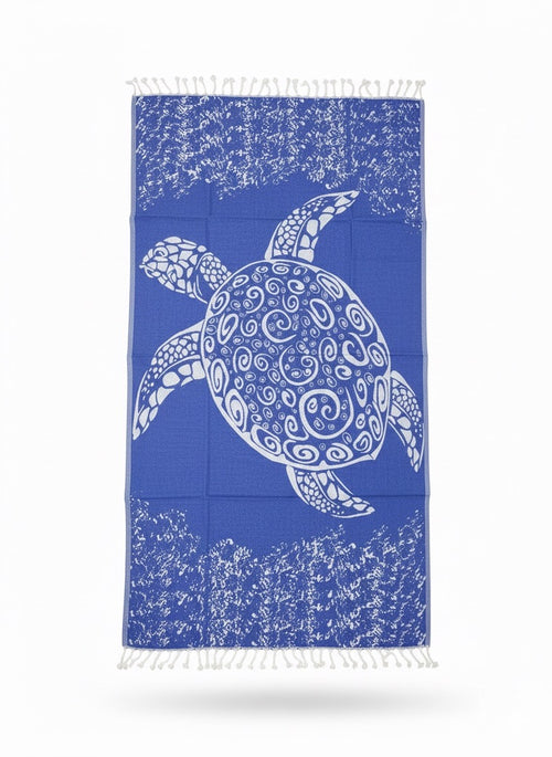 Towel with a white turtle design on a blue background