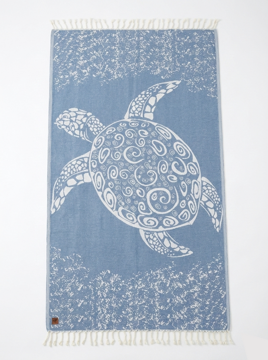 Towel with a white turtle design on a blue background